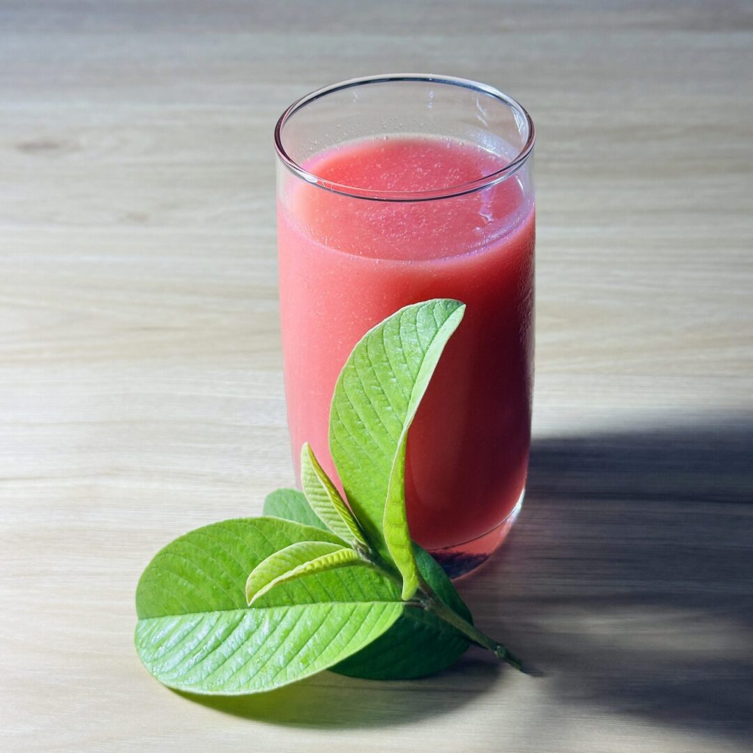 Pink juice and green guava leaves