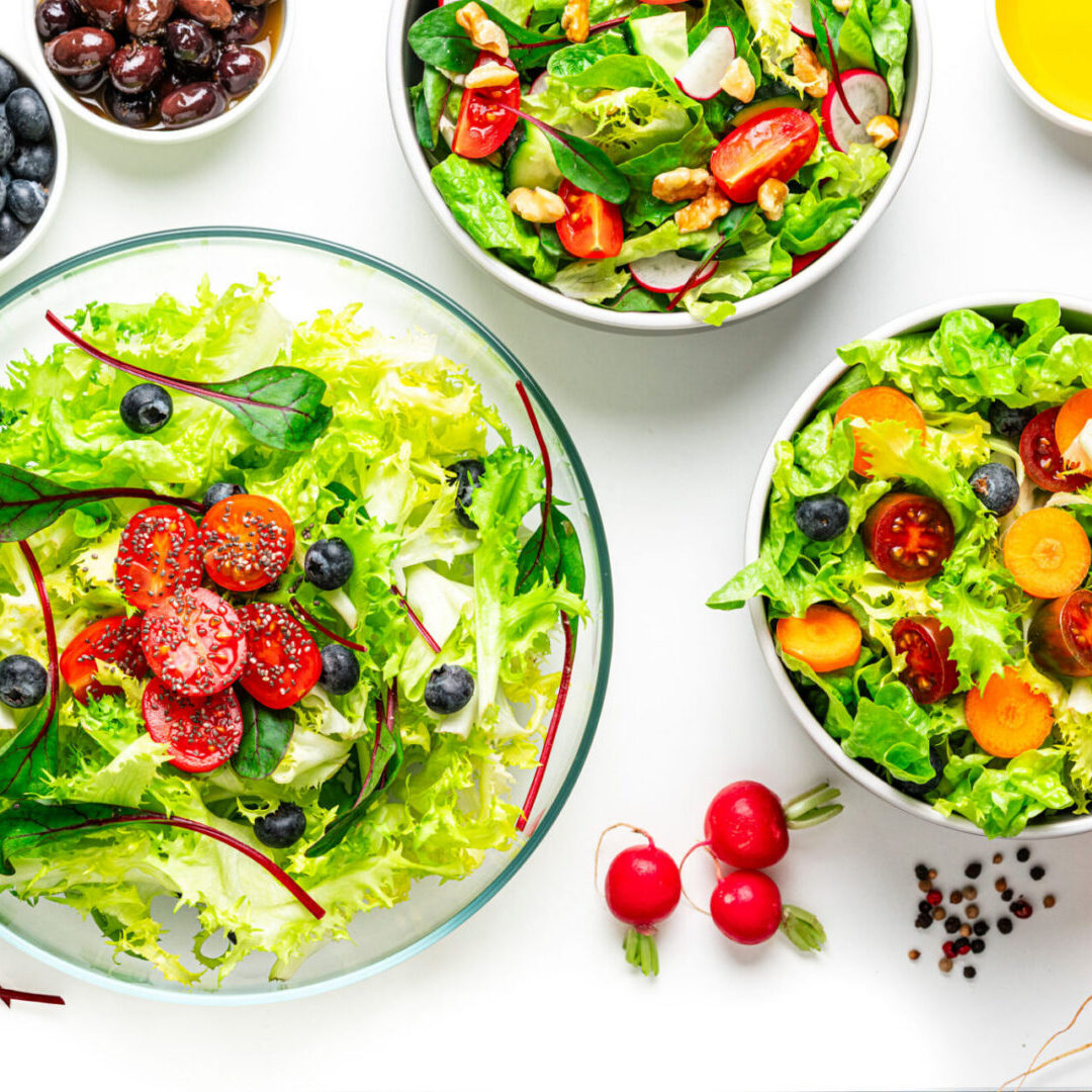 Fresh salad bowls with colorful vegetables