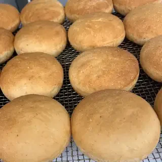 Golden brown buns cooling on wire rack
